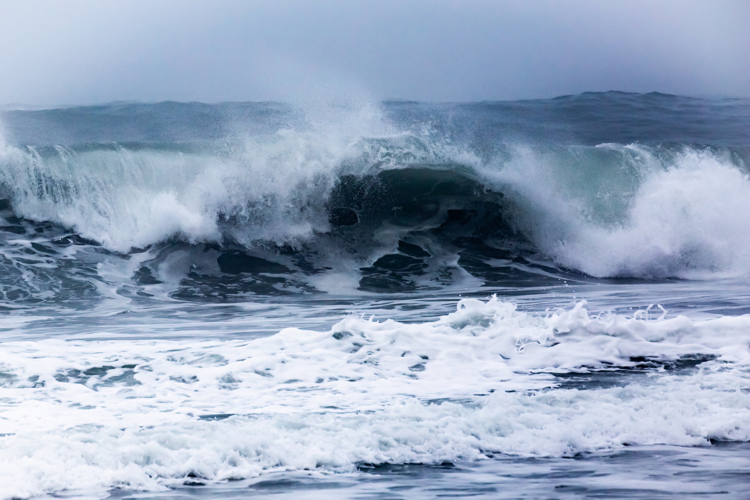 Ocean waves crashing and foaming in the sea.
