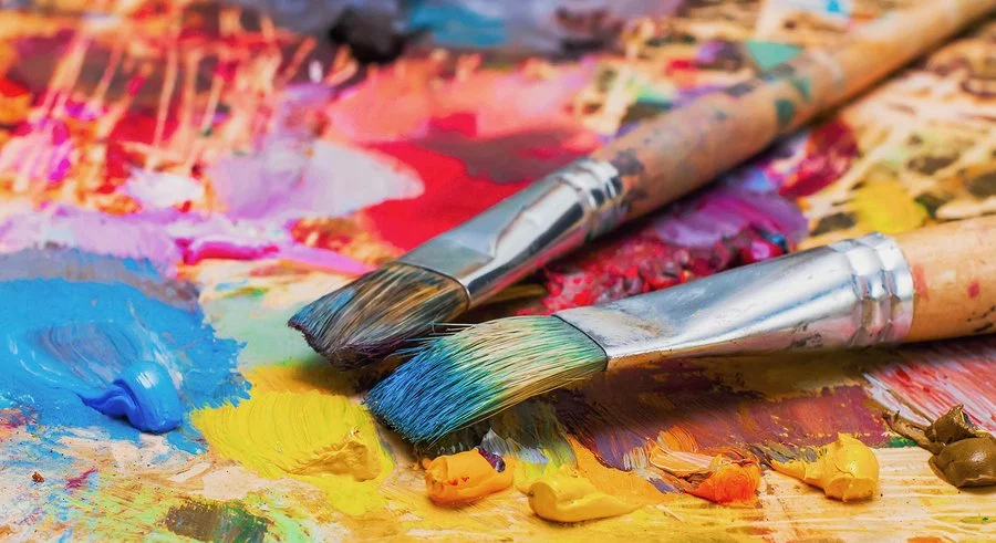 bigstock-Used-Brushes-On-An-Artist-s-Pa-110849459.jpg