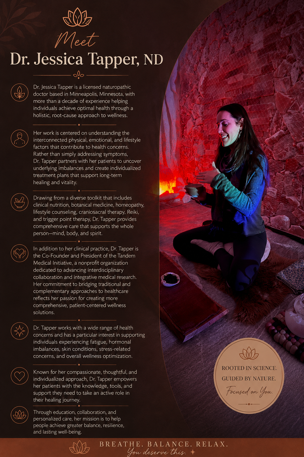 A woman practicing yoga or meditation at a wellness center with a textured red stone wall background, sitting cross-legged on a mat and holding a bowl.