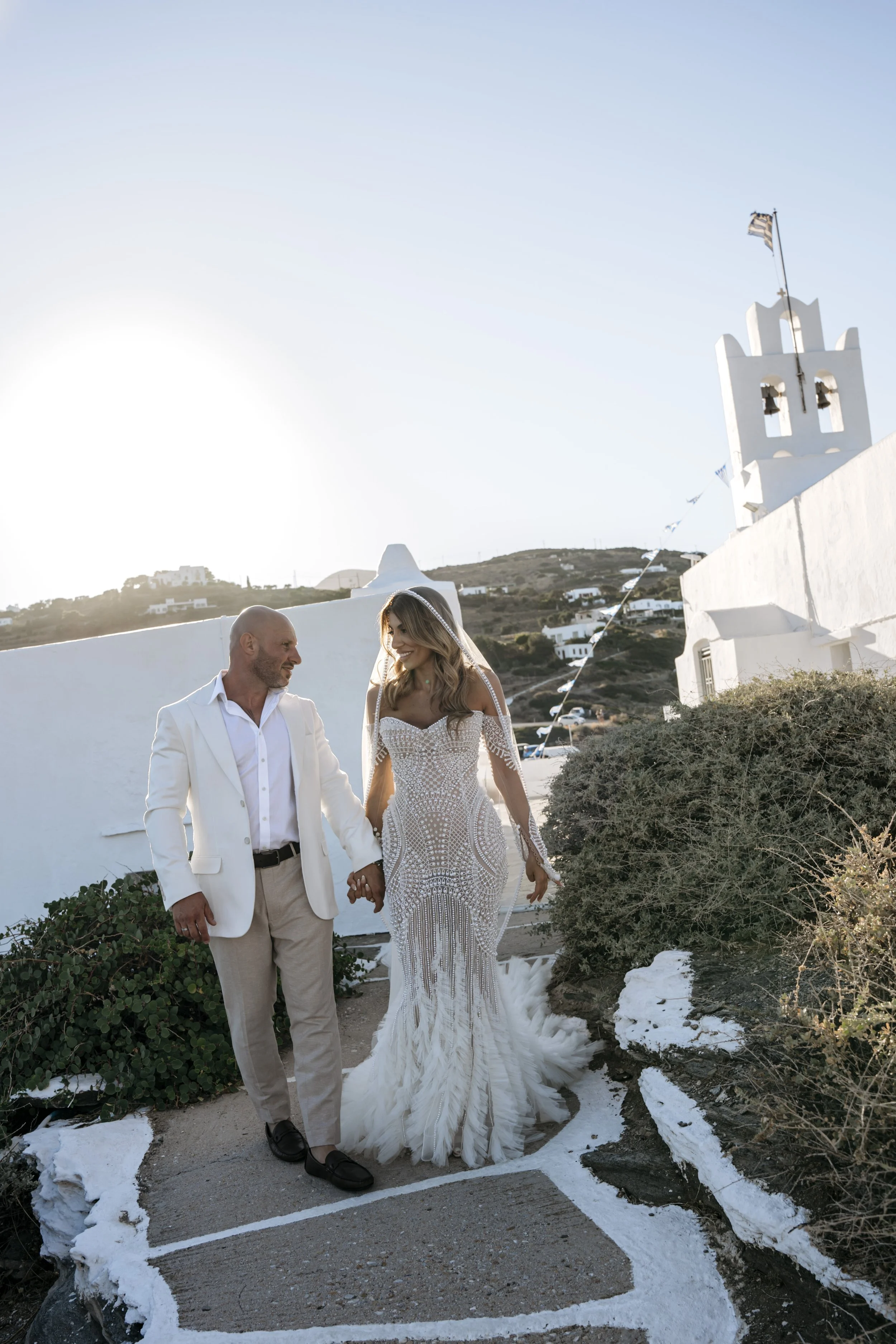 Bride and groom during their couple portraits in Sifnos, Greece, with the bride wearing natural bridal makeup.
