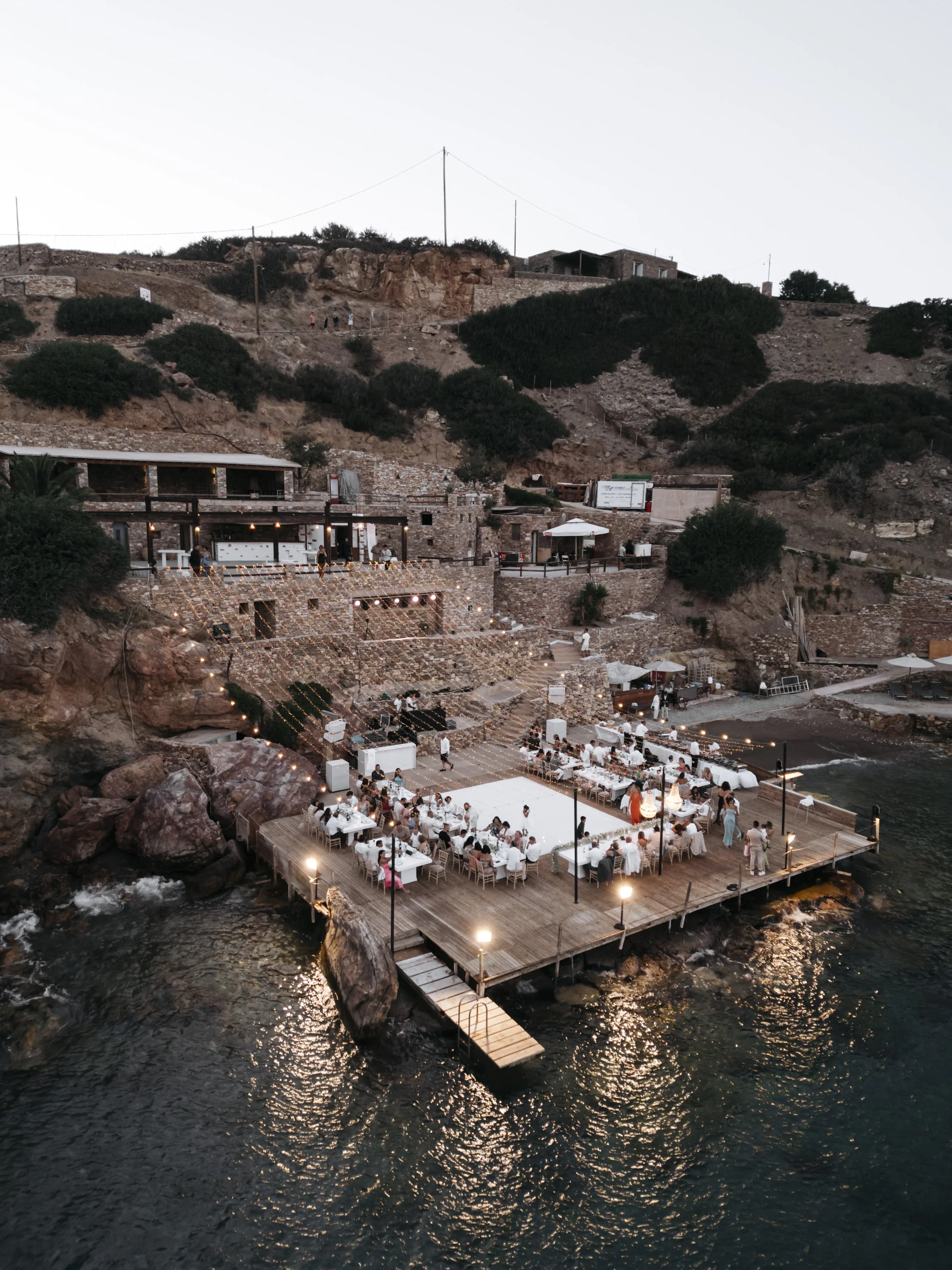 Destination wedding reception at Lazarou Beach in Sifnos, Greece, featuring a seaside venue and sunset celebration.