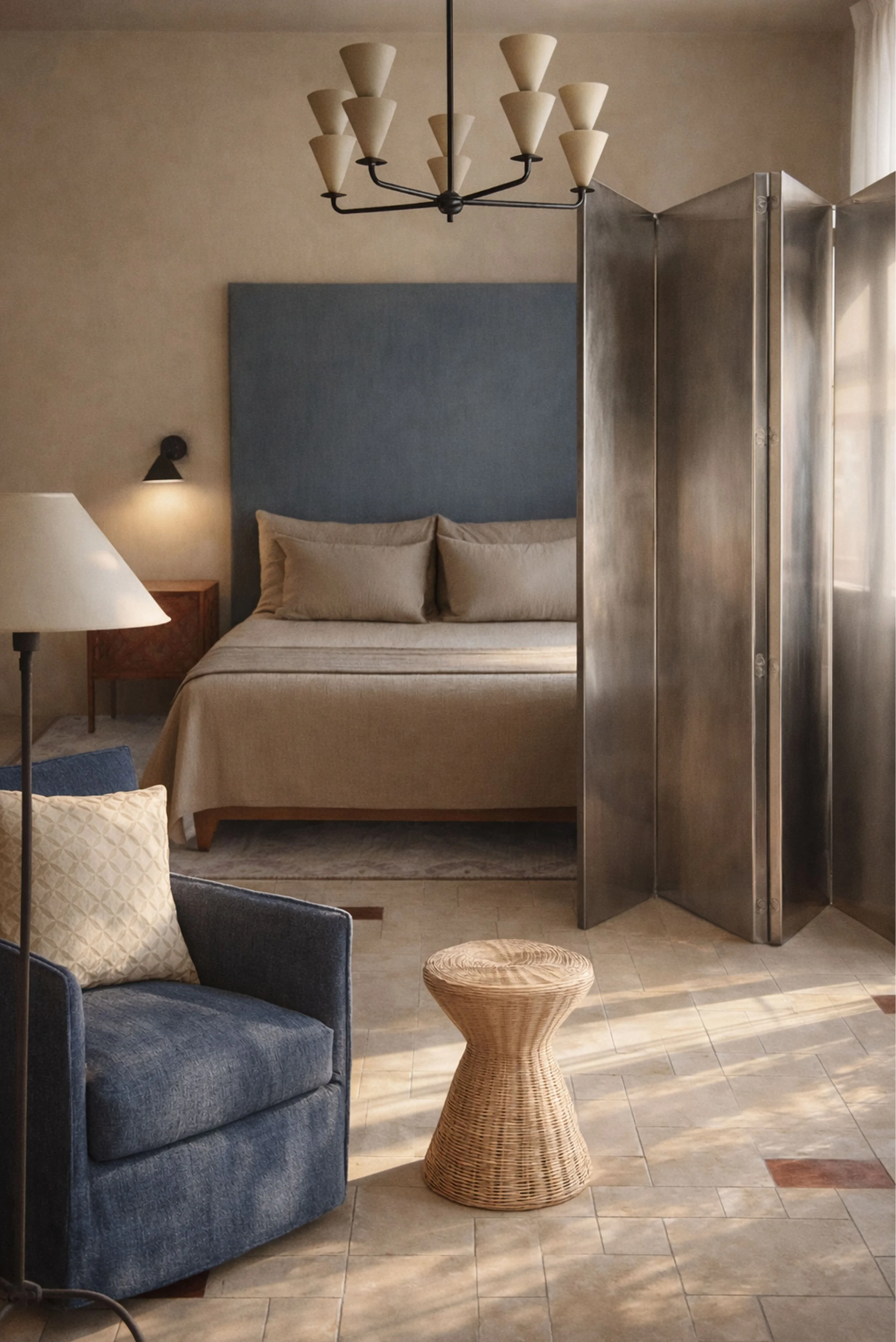 Modern bedroom interior with blue headboard, neutral bedding, soft natural light, tiled floor, and contemporary furnishings