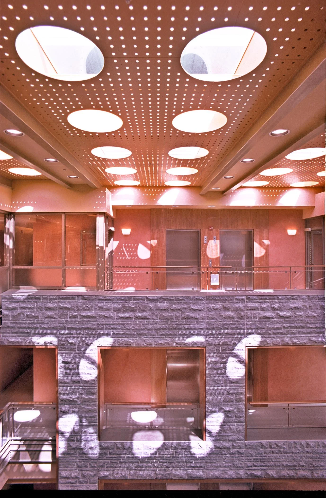 Kingston KFL&A Health Unit interior rock walls and offices. Project by Shoalts and Zaback Architects.