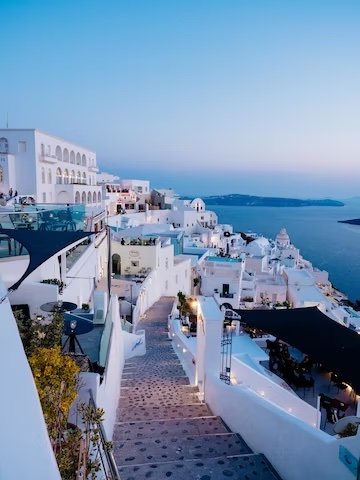 vertical-high-angle-shot-white-buildings-santorini-greece_181624-31643.jpeg