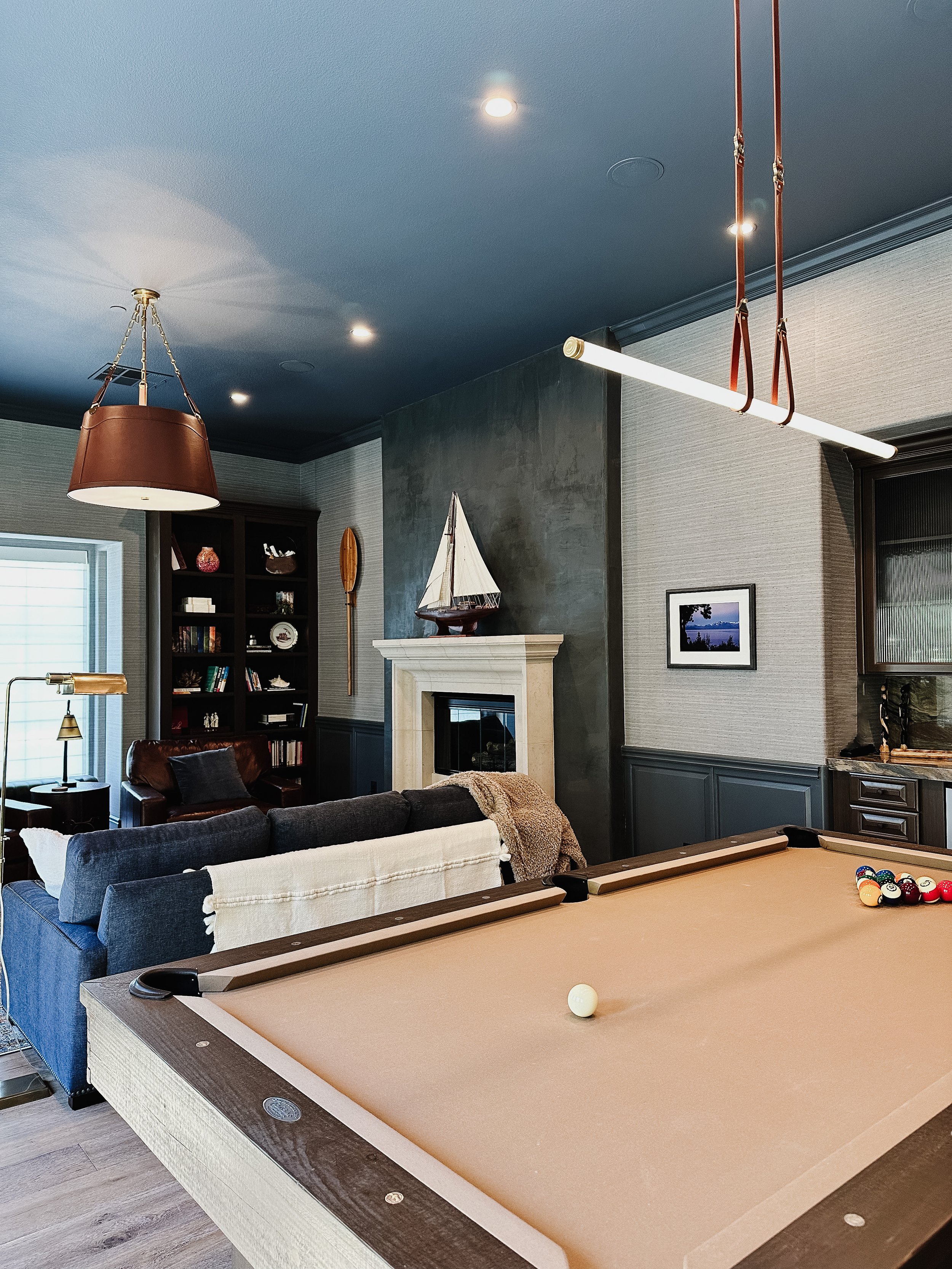 aurora-interiors-rustic-traditional-photo-club-room-deep-blue-grey-fireplace-surround-pool-table-bar.jpg