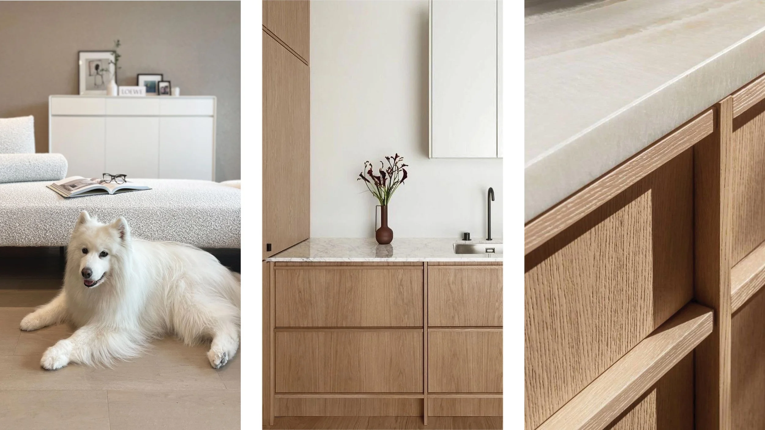 A living room with a white fluffy dog lying on the floor, a bed with a textured bedspread, a white cabinet with picture frames and decor, a brown door, a white wall with a vase of flowers, a marble countertop, and wooden cabinetry.