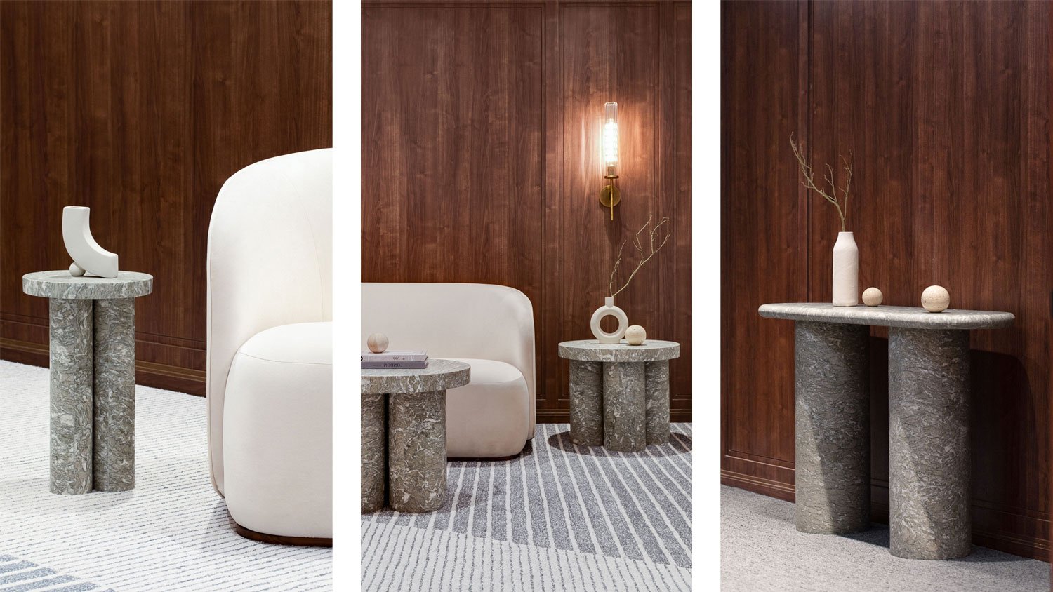 Three interior scenes featuring stone or concrete furniture and decor with a wood-paneled wall background. The first scene shows a small round table with a abstract white sculpture and a white chair. The second scene shows a small round table with a tall white vase and decorative objects, next to a white couch and a wall sconce. The third scene shows a small round table with a white vase and decorative spheres, all against a wood wall.