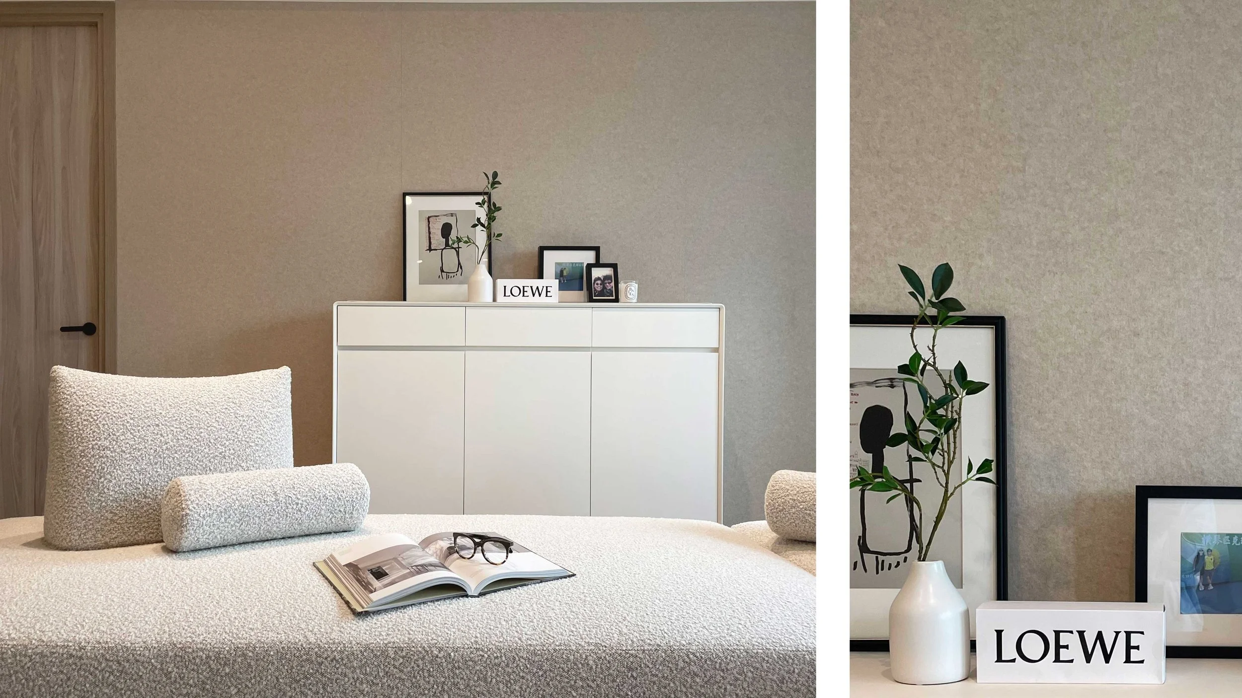 A modern living room with a white sofa, an open magazine, and sunglasses on it. In the background, there's a white sideboard with framed art, photos, a white vase with a green plant, and a LOEWE sign. To the right, a potted plant is visible, and part
