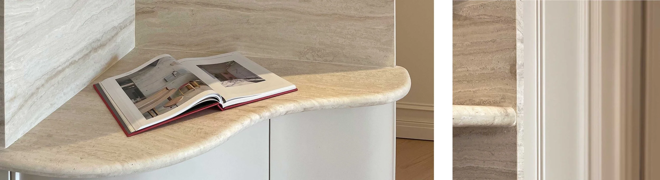 Open magazine on a curved marble countertop in an interior space.