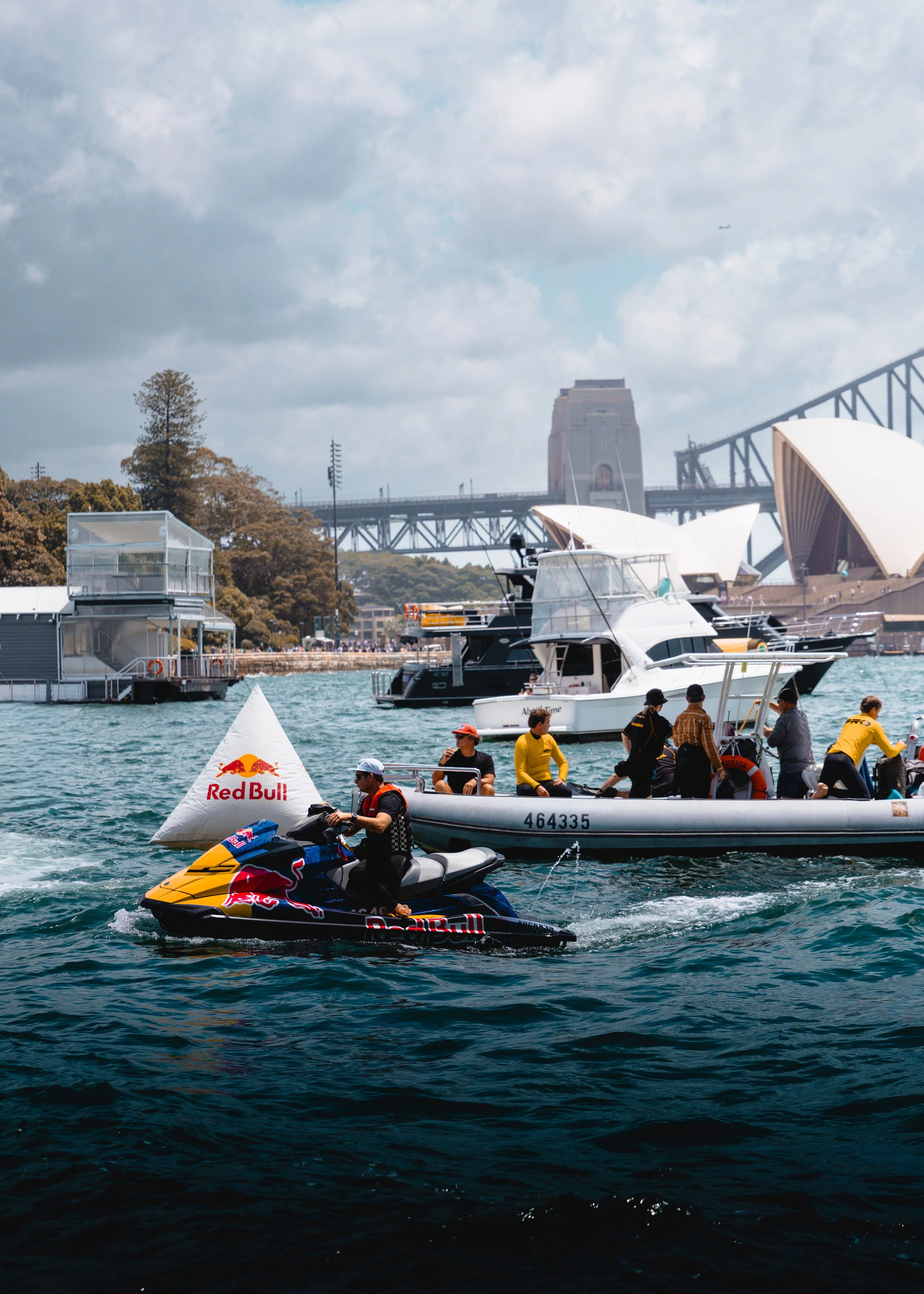 Event Photography | Redbull extreme sports, Sydney A group of people on a boat and a jet ski in Sydney Harbour with the Sydney Opera House and Harbour Bridge in the background.