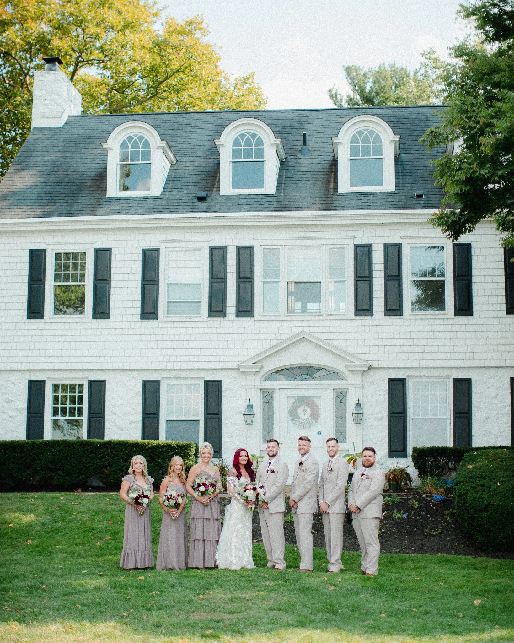 Wedding party lined up in front of a white colonial house, New Jersey wedding