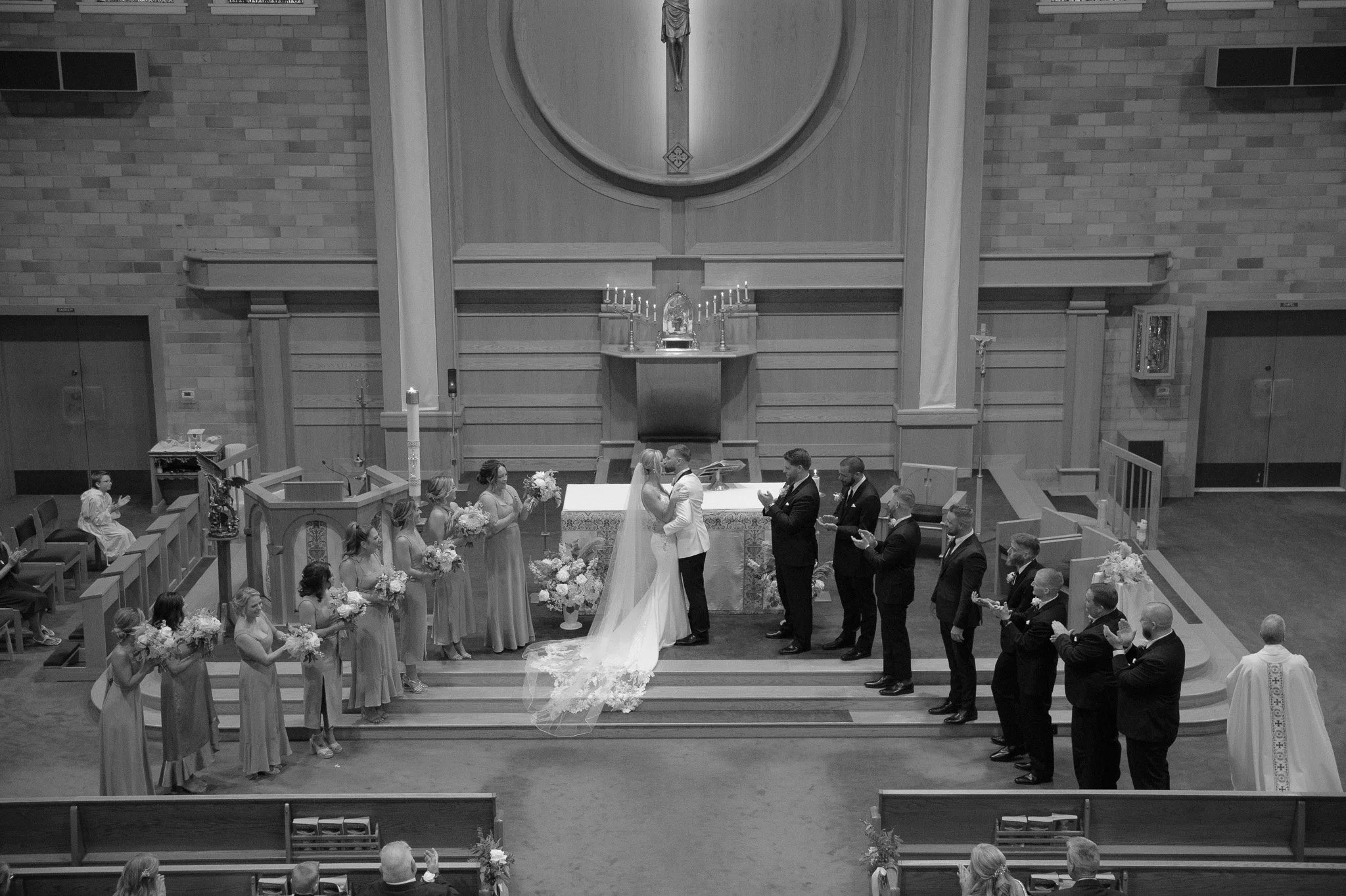 Church wedding ceremony at the altar with bridal party, black and white