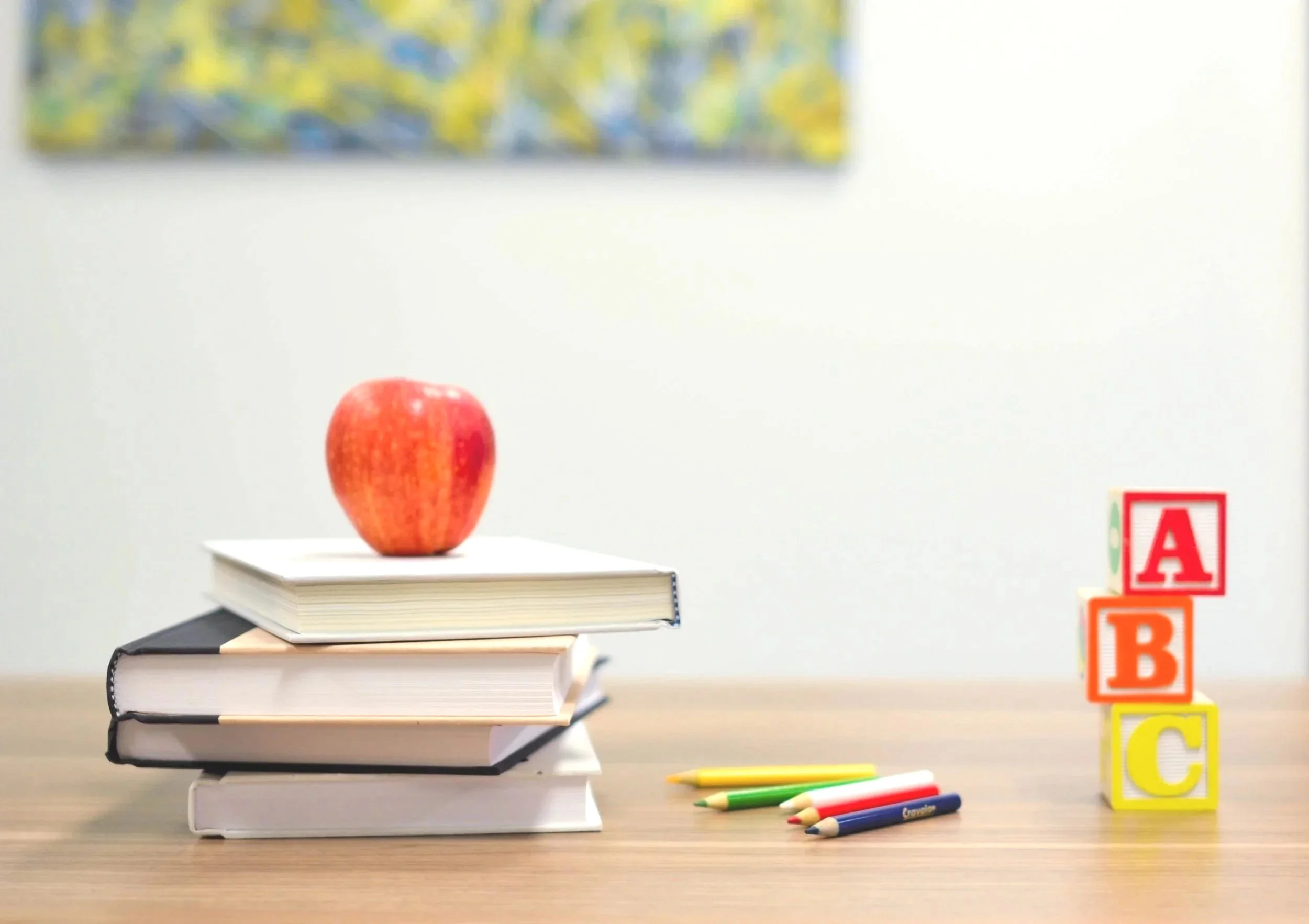 An educational setup featuring books, alphabet blocks, and learning tools designed to support an early literacy development program within an academic preschool curriculum. This setup helps children build reading, language, and foundational learning 