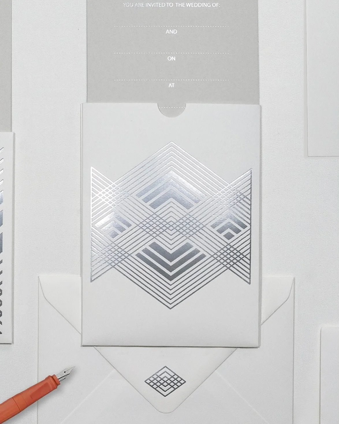 Pictured here in matt platinum and a lovely soft white matt paper with inserts in pale grey. The pattern is hot foil printed, this process also embosses the paper so all the items have a beautifully tactile feel. The pocket folder contains a folded i