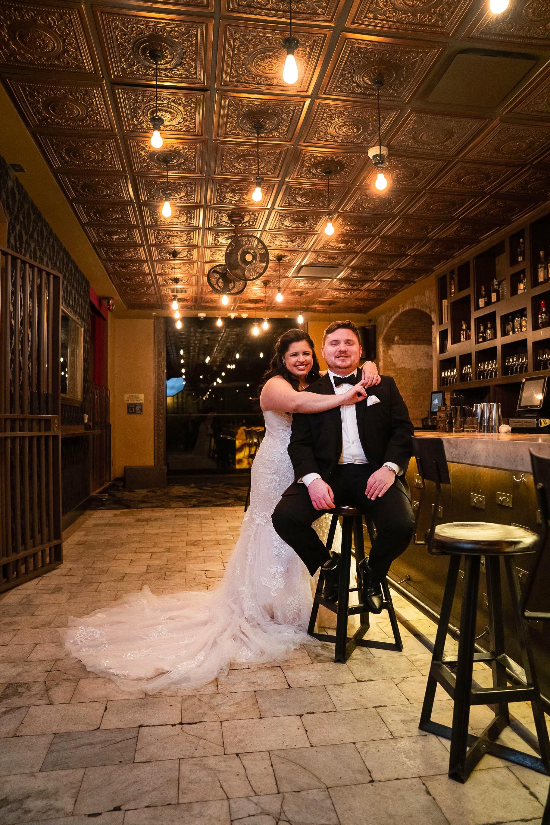 Bride & Groom stand together at bar for wedding day photo at Metro at the 9 in Cleveland, Ohio