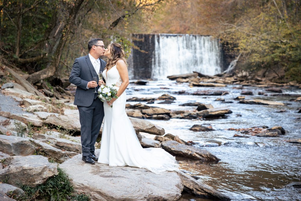 0029-Roswell-Mill-Wedding-bride-and-groom-waterfall-Kristin-Cheatwood.JPG