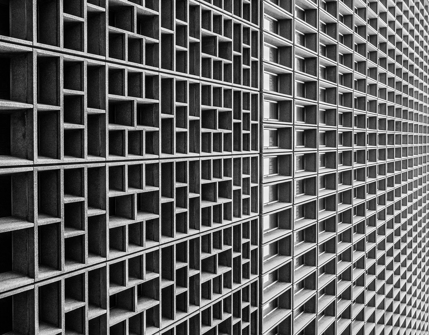 a black and white abstract photo of a building  with many squares and rectangles