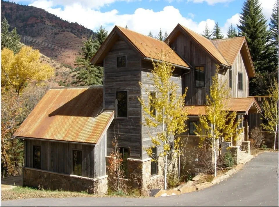 grey wood home with orange roof | Old house roof replacement | historic building renovation | Troost Roofing