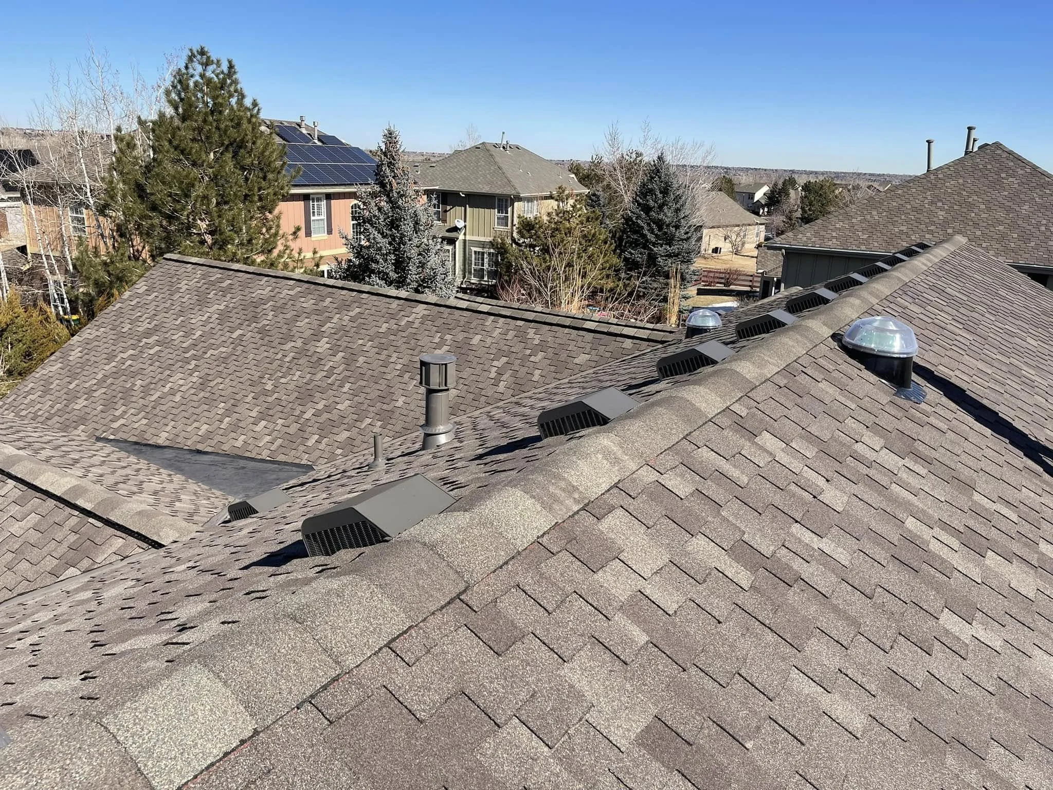 an example of Bailey, CO roofing: class 4 asphalt shingles with a row of vents for climate control.
