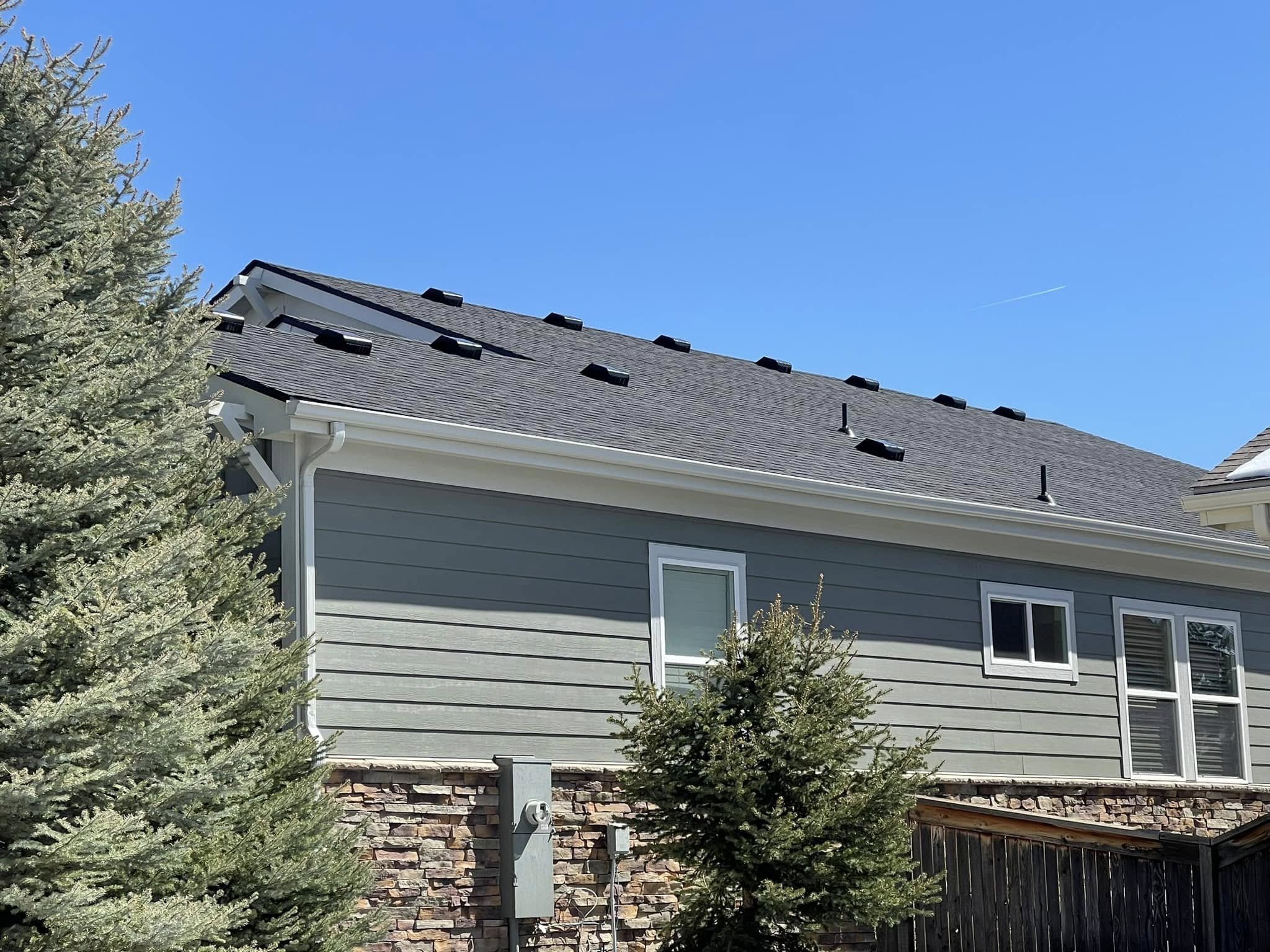 A home with Coal Creek roofing: grey shingles with many raised vents.