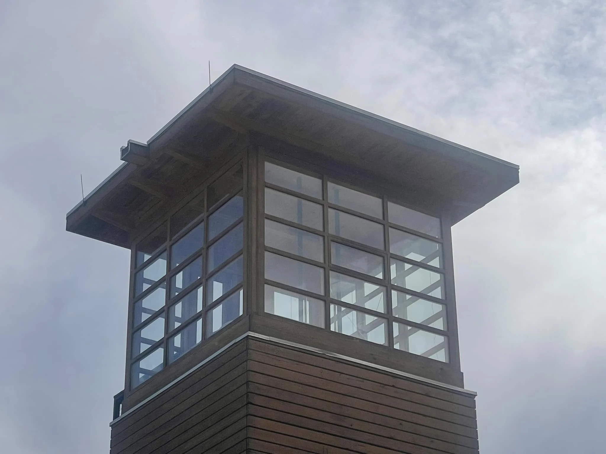 an example of roofing in Idledale, CO: a home with a windowed tower and drainage system.