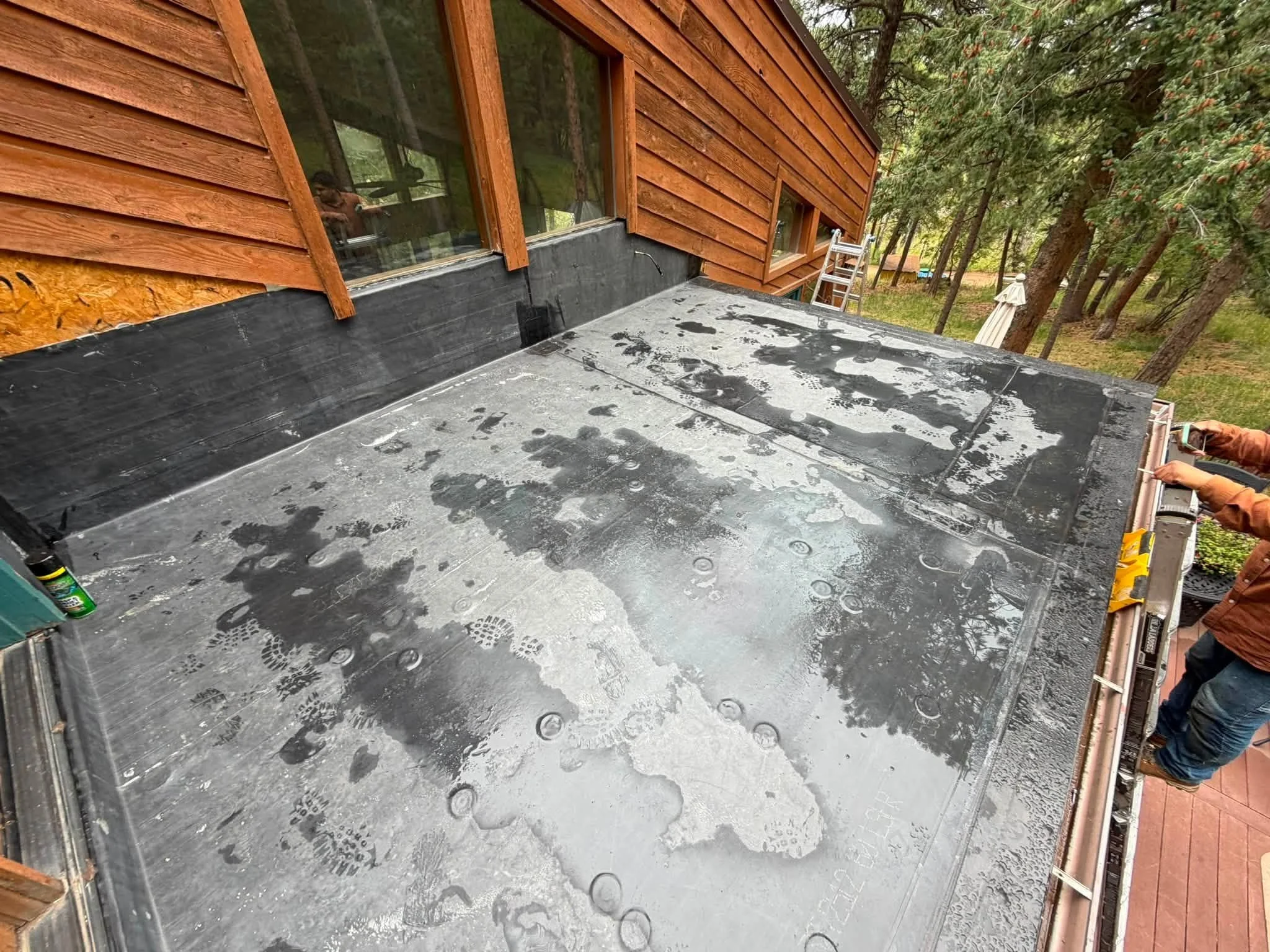 work by a roofing contractor in Golden: a rubber roof installed on a home with wood siding