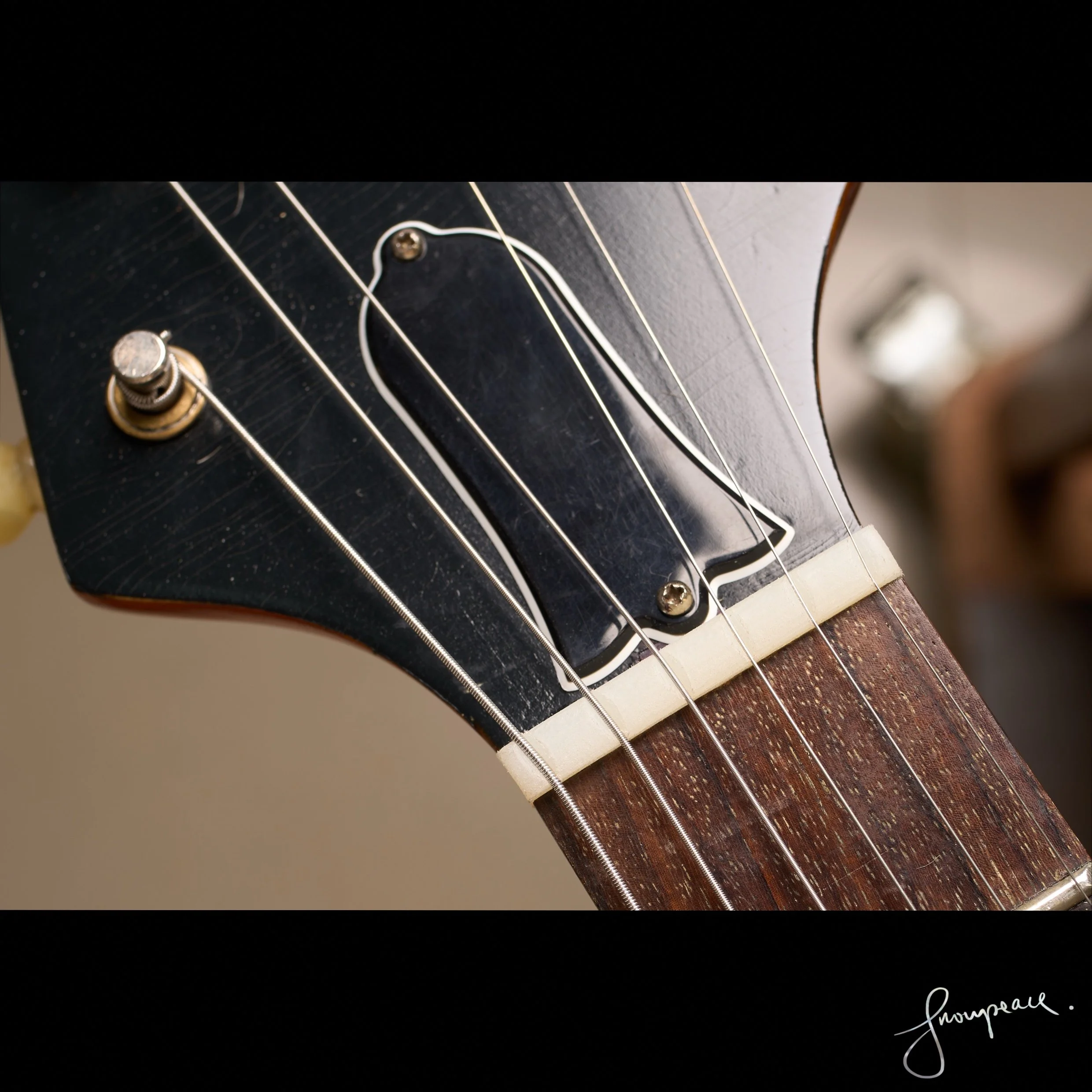 Hand-crafting a Gibson-spec Nylon 6:6 nut, precision-filing slots for optimal tonal transfer.jpg