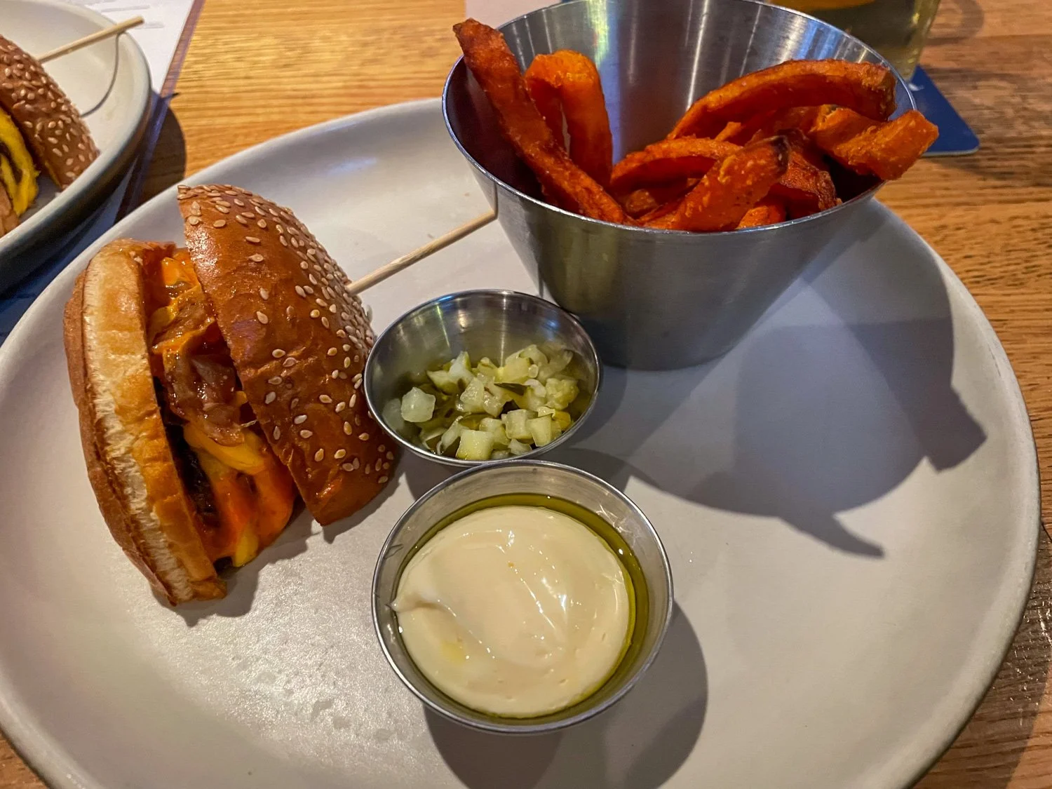 A photograph of a burger and sweet potato fries at The Local Public Eatery in Winnipeg, Manitoba, Canada