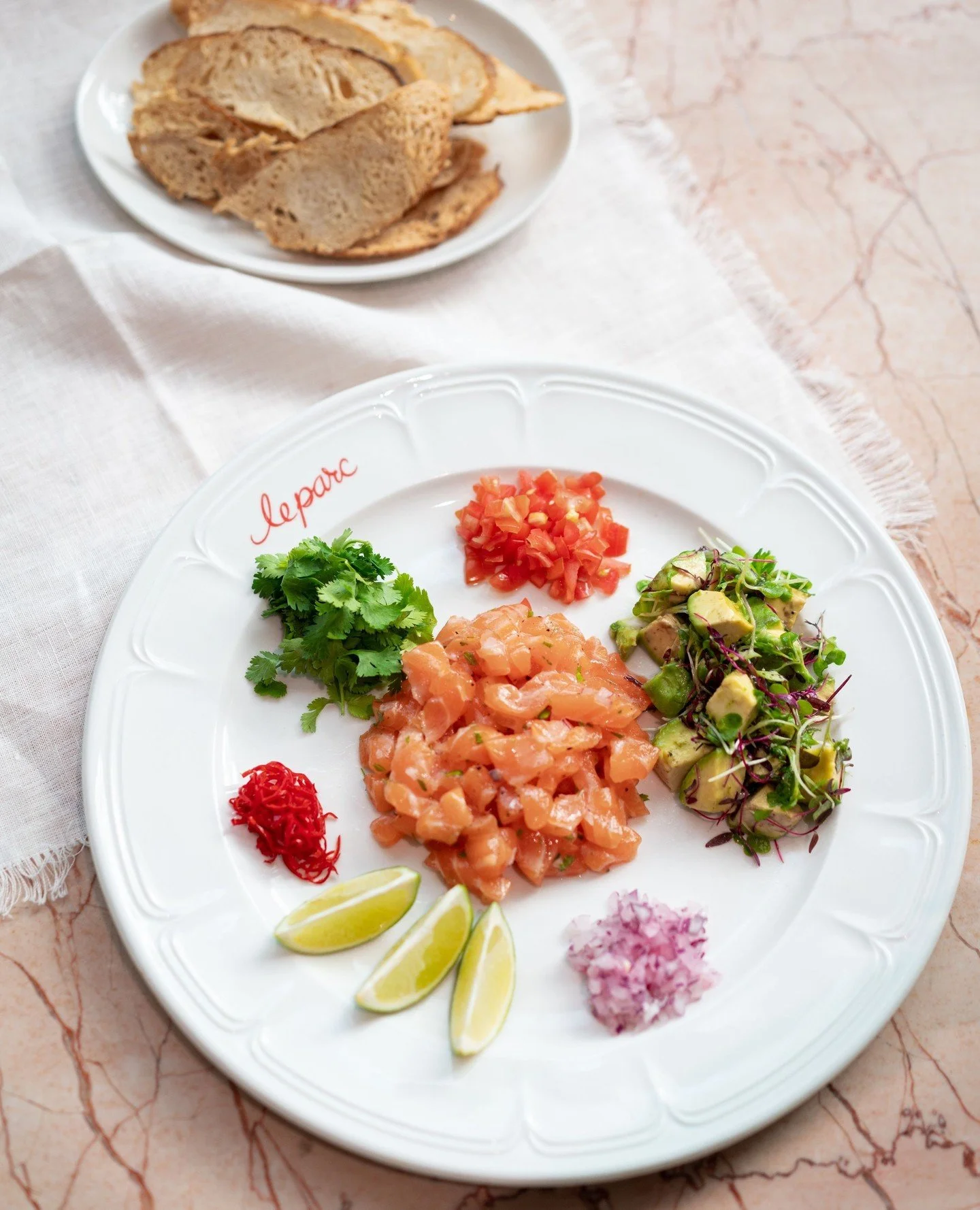 Summer freshness on a plate. Salmon Tartare. Avo salsa, cherry tomato, lime, housemade melba toast.⁠
⁠
#salmontartare #lightlunch #leparc #leparcbytashas #bytashas⁠