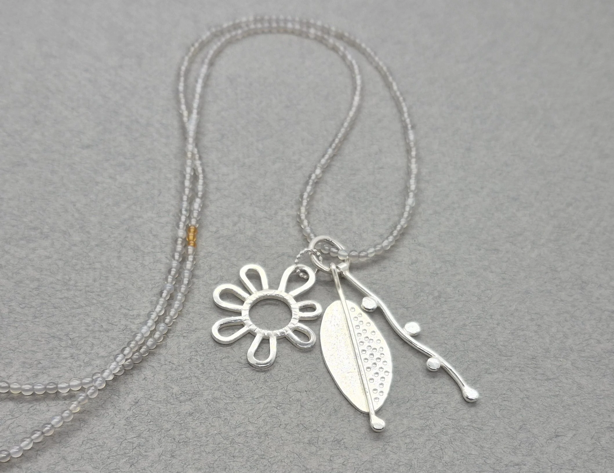 Silver sunflower and grey agate pendant
