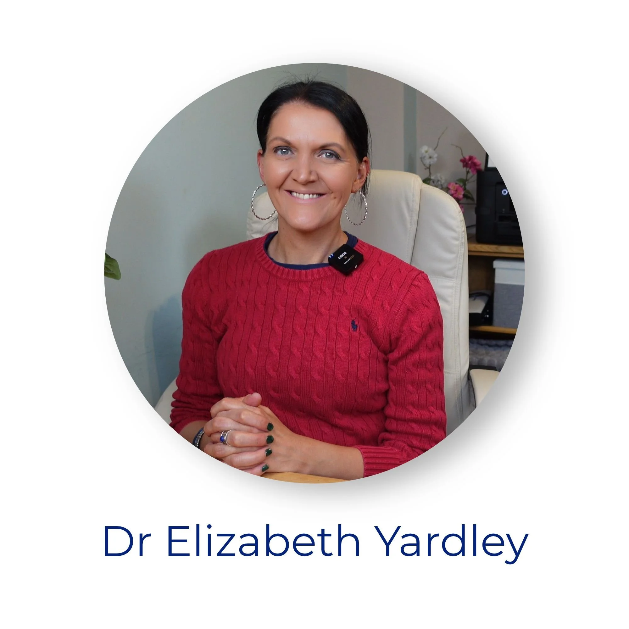 Dr Elizabeth Yardley, founder of Degree Doctor, smiling at the camera in a red jumper, seated at her desk. Circular portrait photograph with her name displayed underneath.