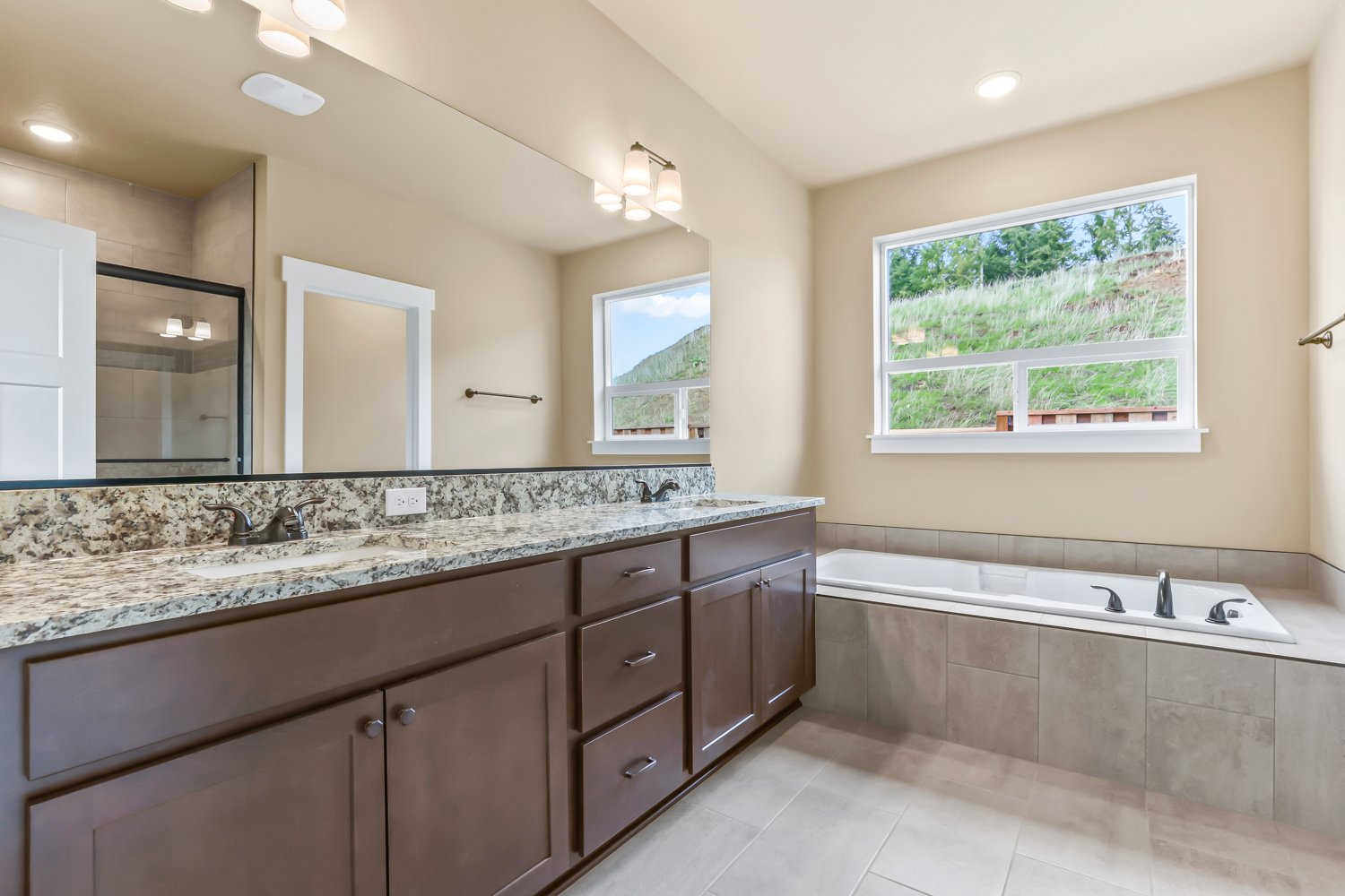 Master Bathroom, Countertop and backsplash Granite Giallo Napoli, Floors Potenza Fawn, Tub Backsplash Catch Tuape Matte 2x2.jpg