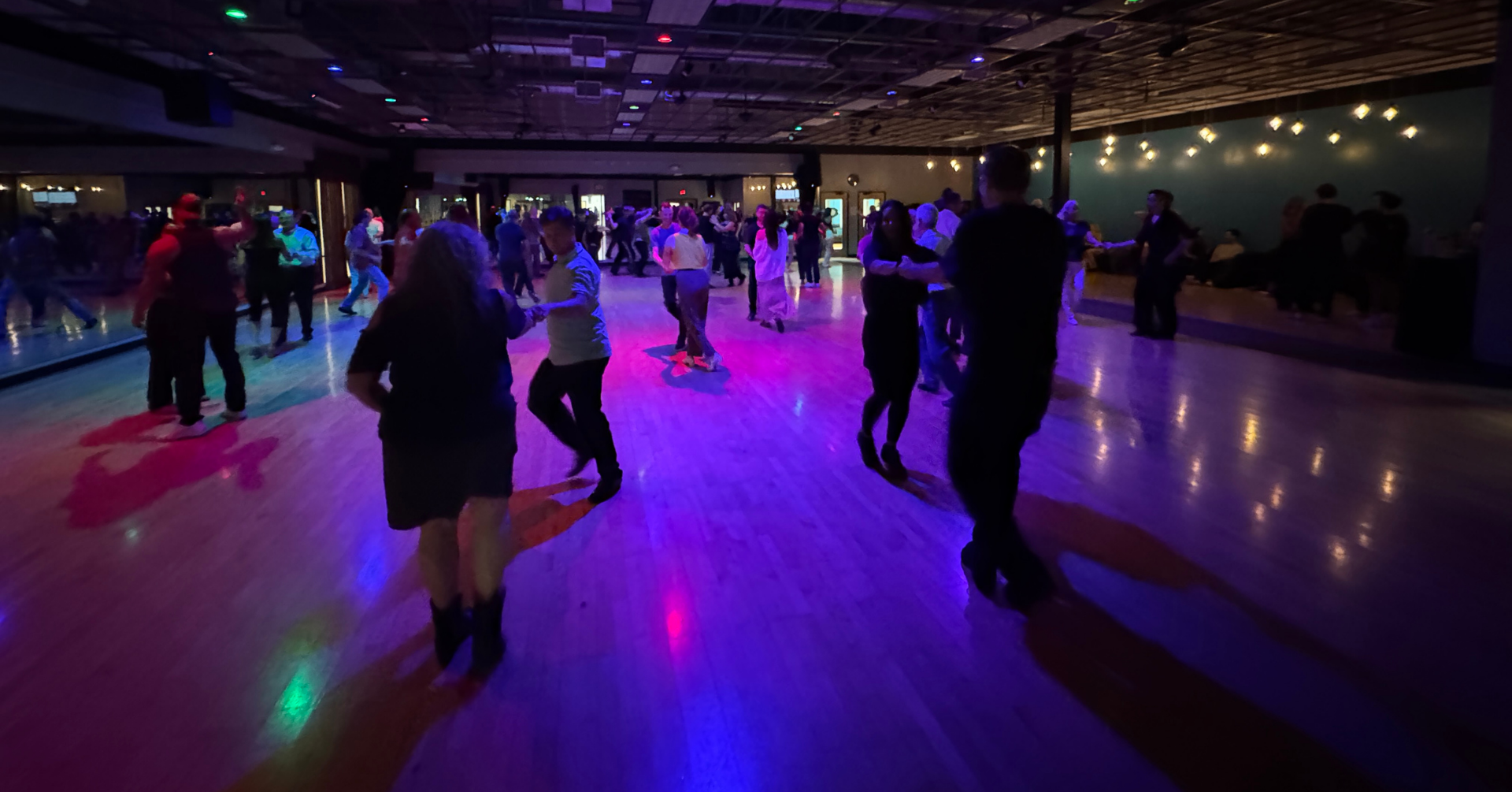 Group of people partner dancing.