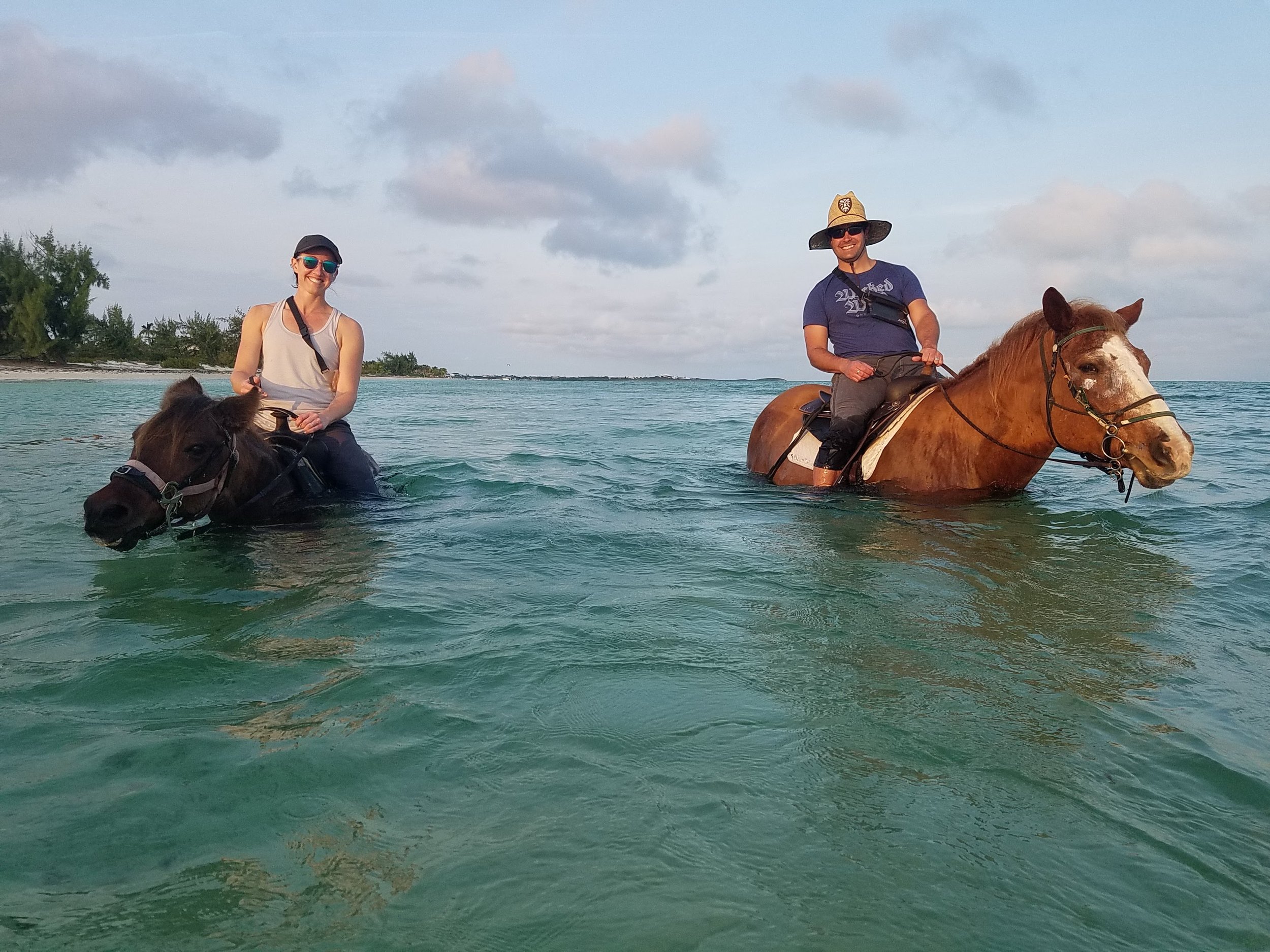 Kristina and Spencer horseback riding in the ocean in Turks and Caicos