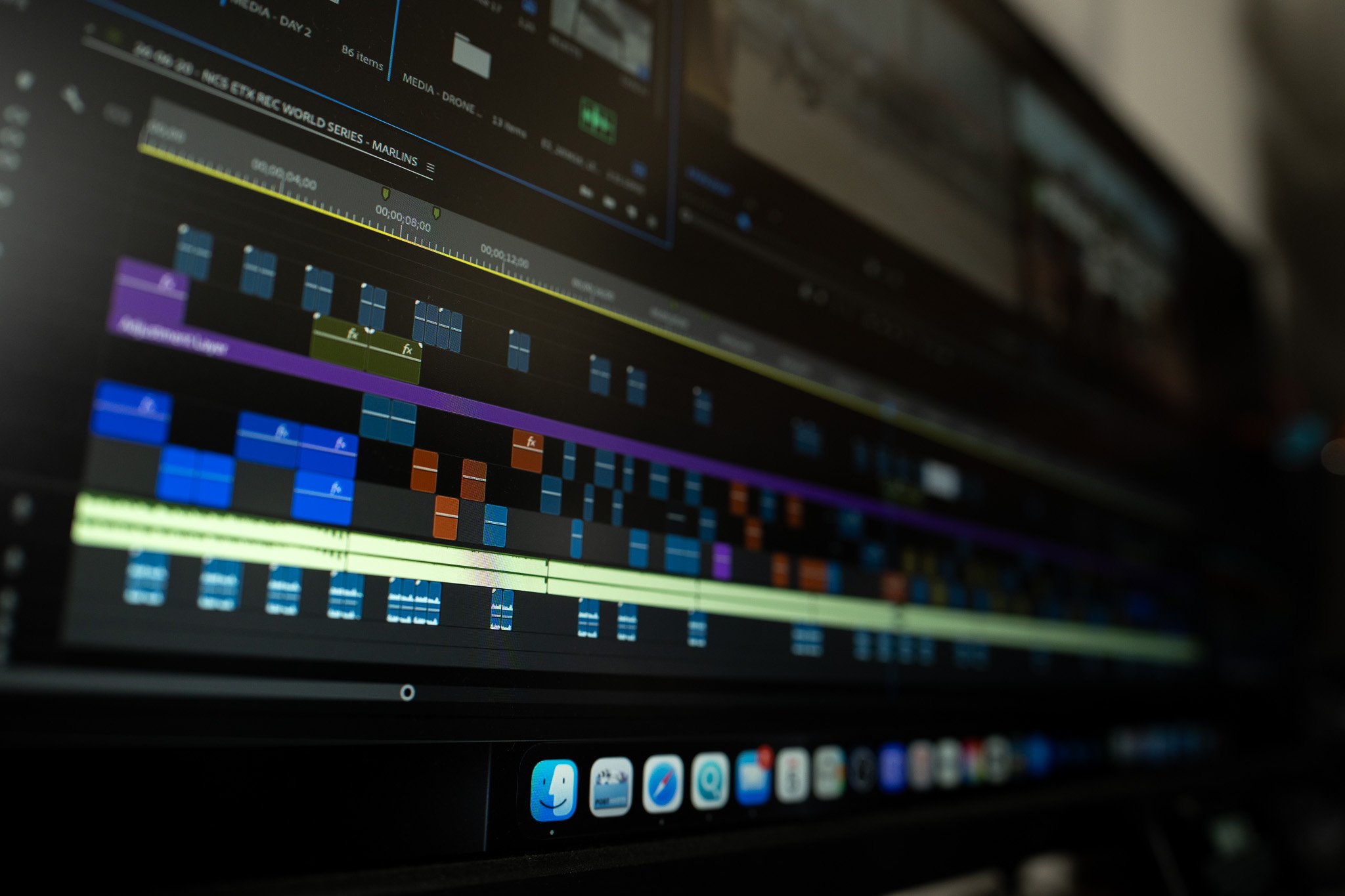 A computer screen displaying a video editing software timeline with multiple colored clips and audio tracks.