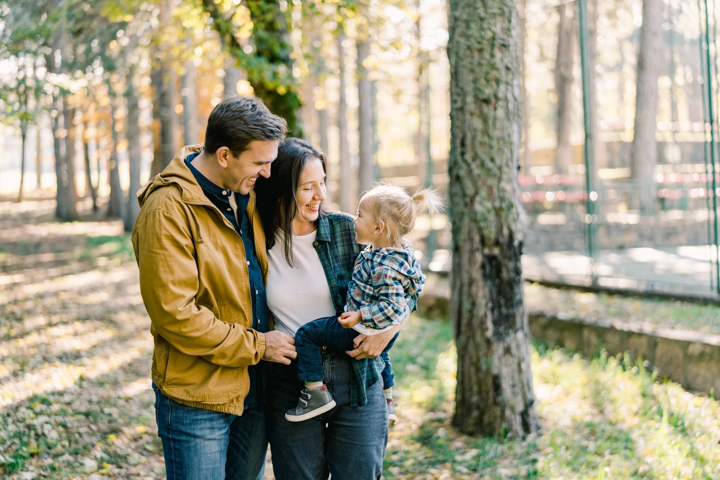 Family walking through a tree-lined street in one of Cleveland’s best neighborhoods during a daily routine