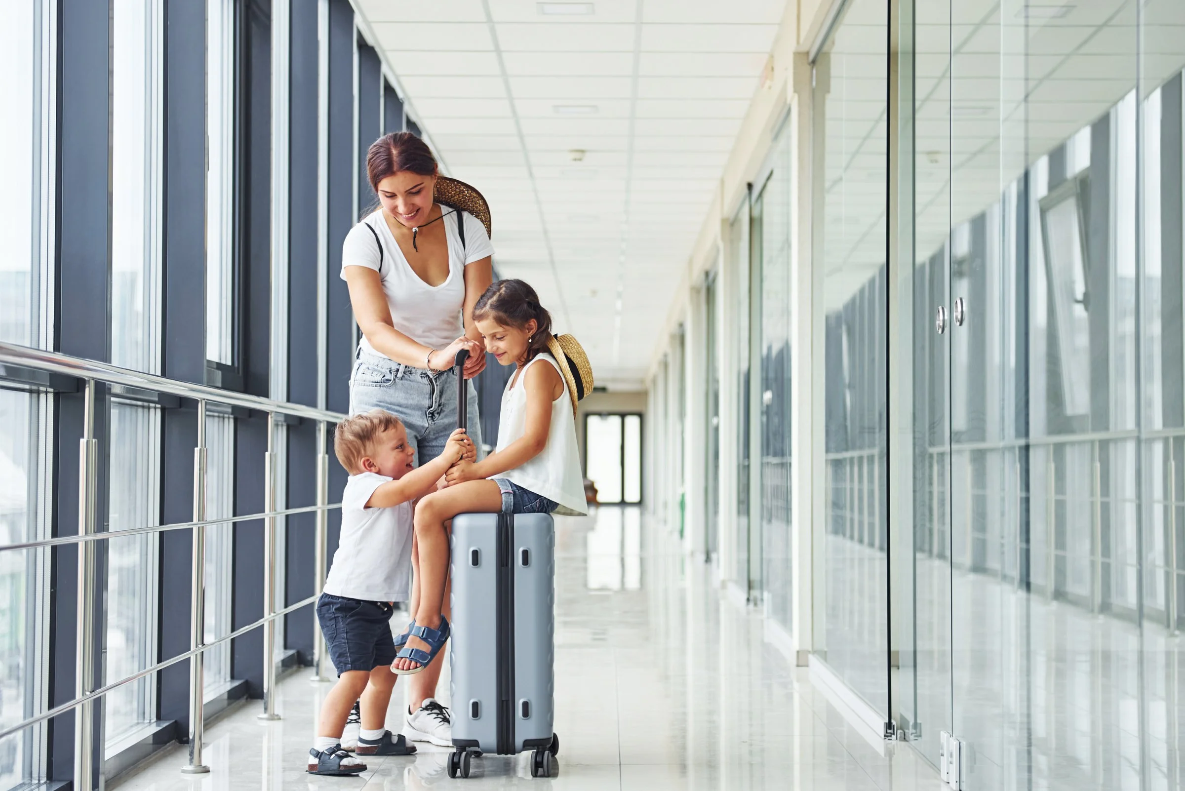 Nanny assisting a family with childcare during travel while parent manages logistics