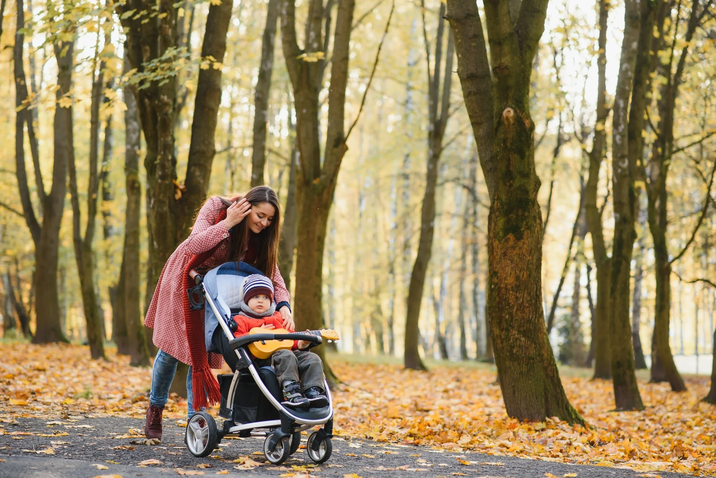 Professional nanny pushing stroller through residential Shaker Heights neighborhood