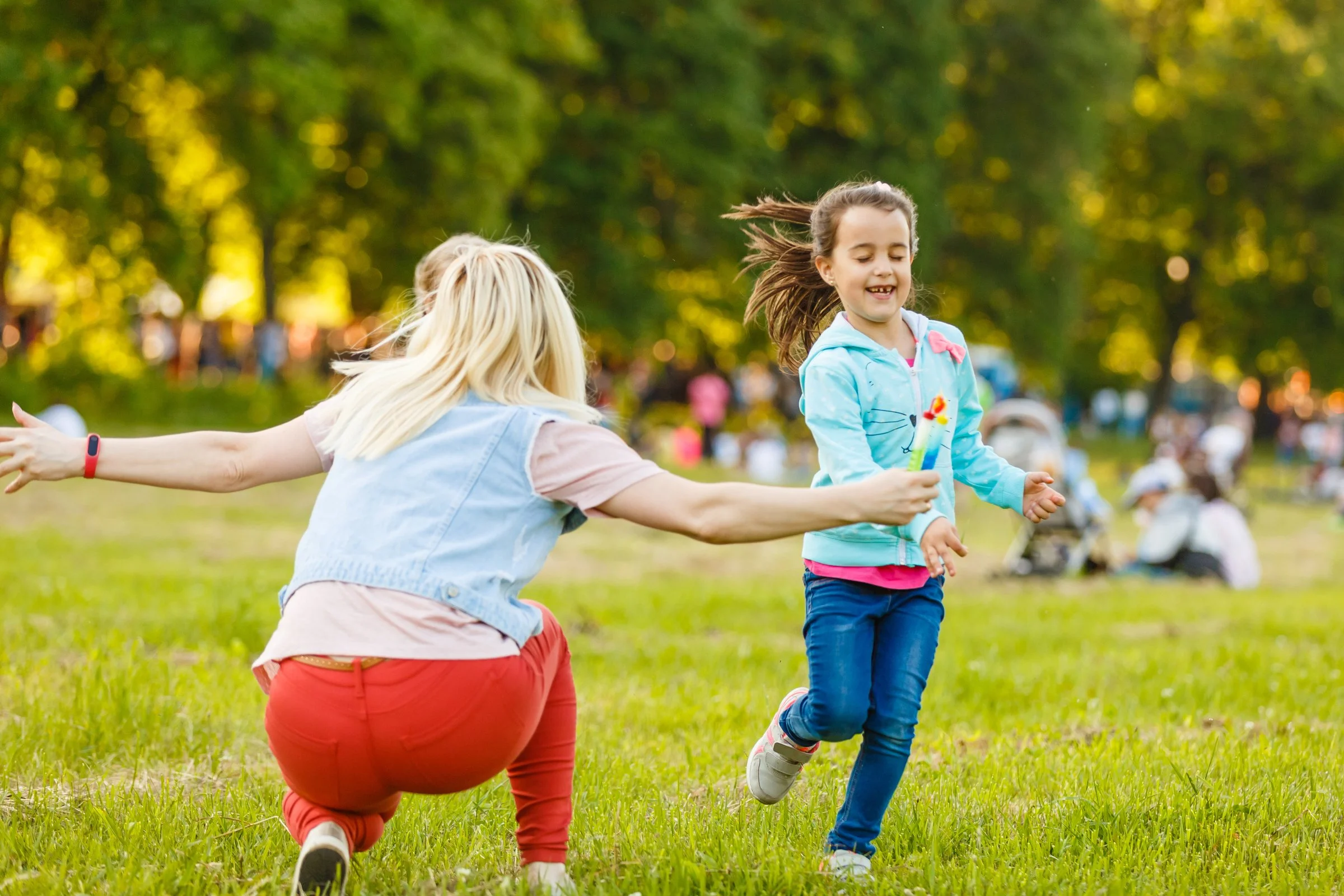 Children playing at Boston Common with nanny during summer day