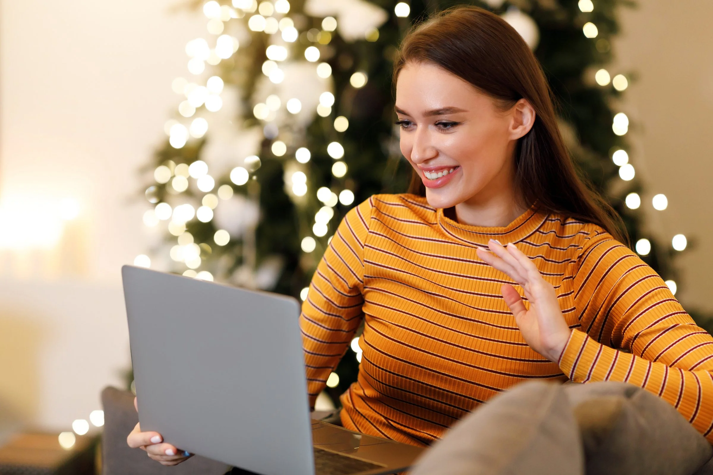 Nanny smiling on a video call during a virtual holiday-season interview.