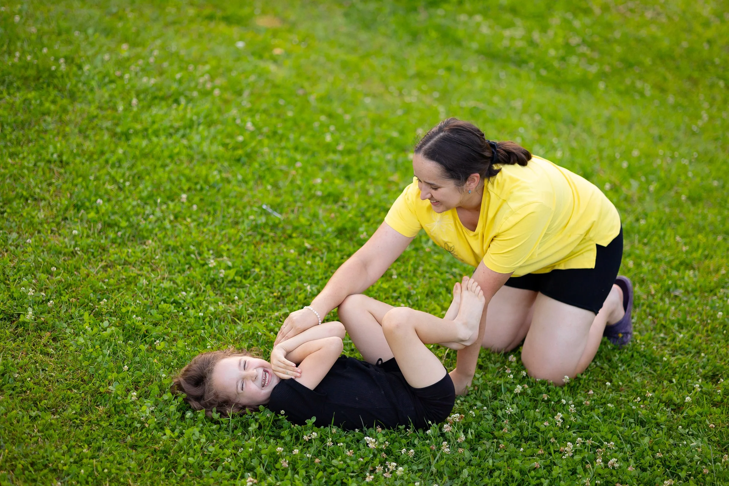 Child playing outdoors in Boston neighborhood with caregiver
