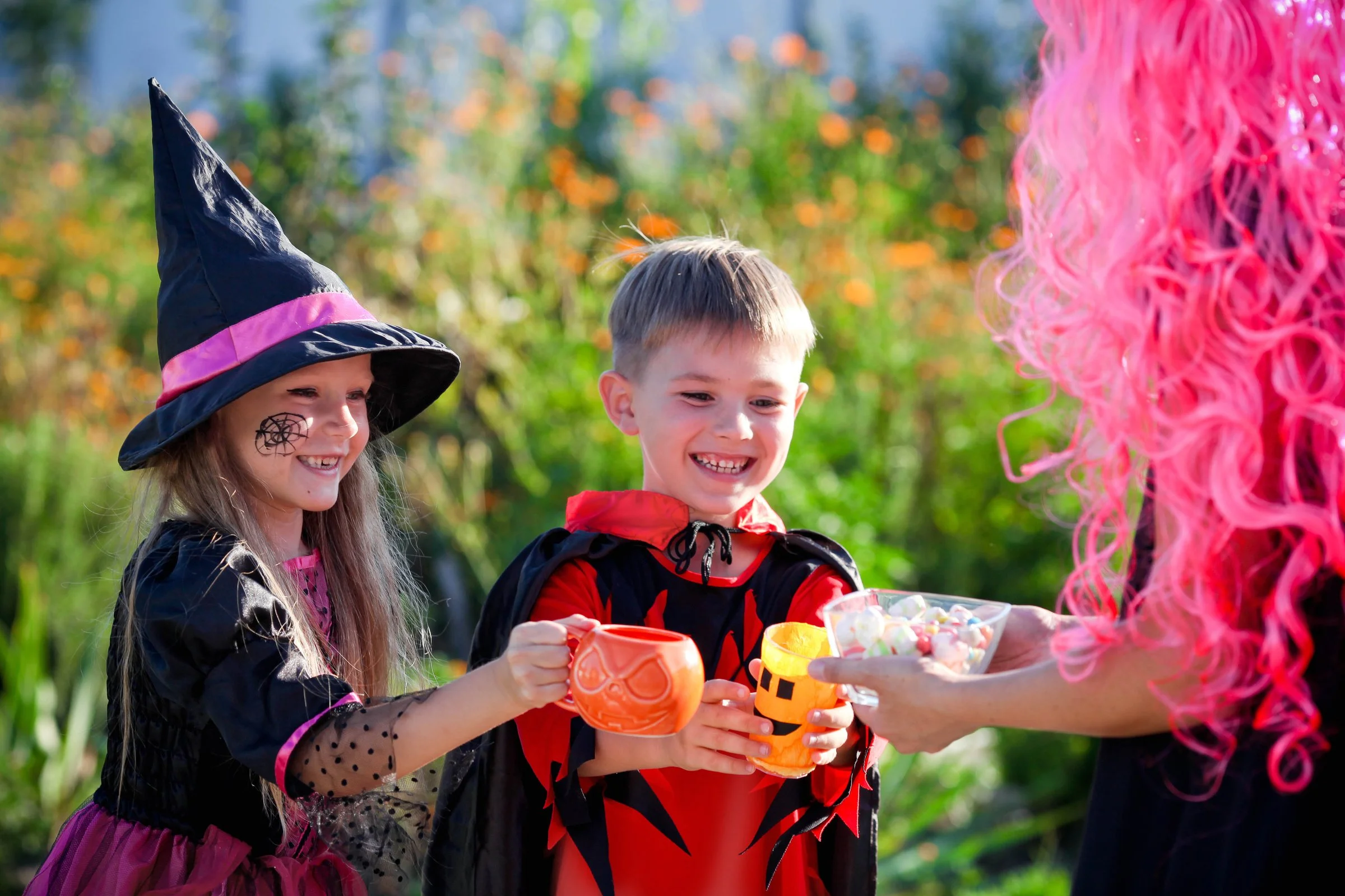 Children dressed in Halloween costumes going trick-or-treating in their neighborhood.