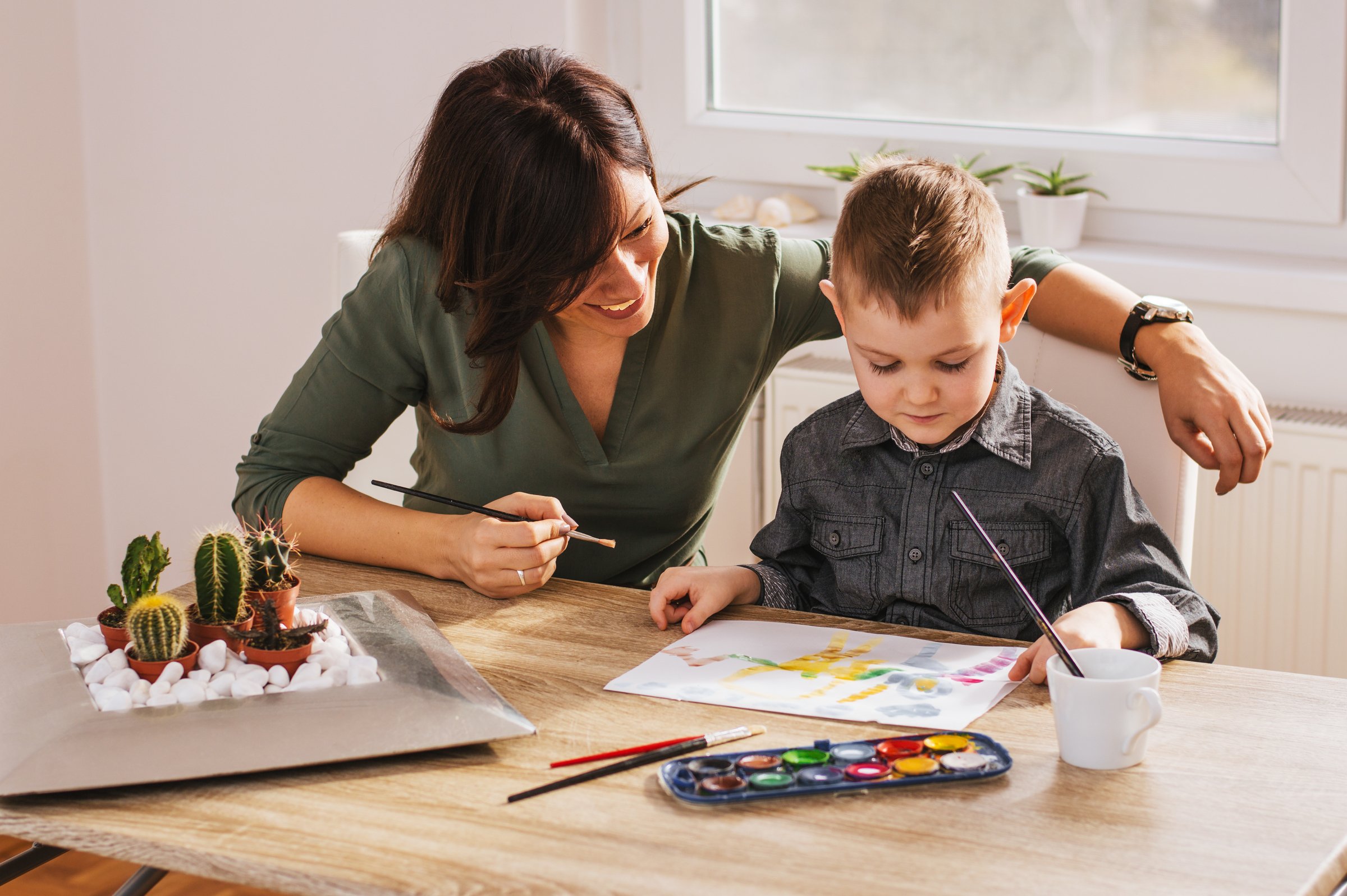 Professional nanny supporting child learning and structured activities at home