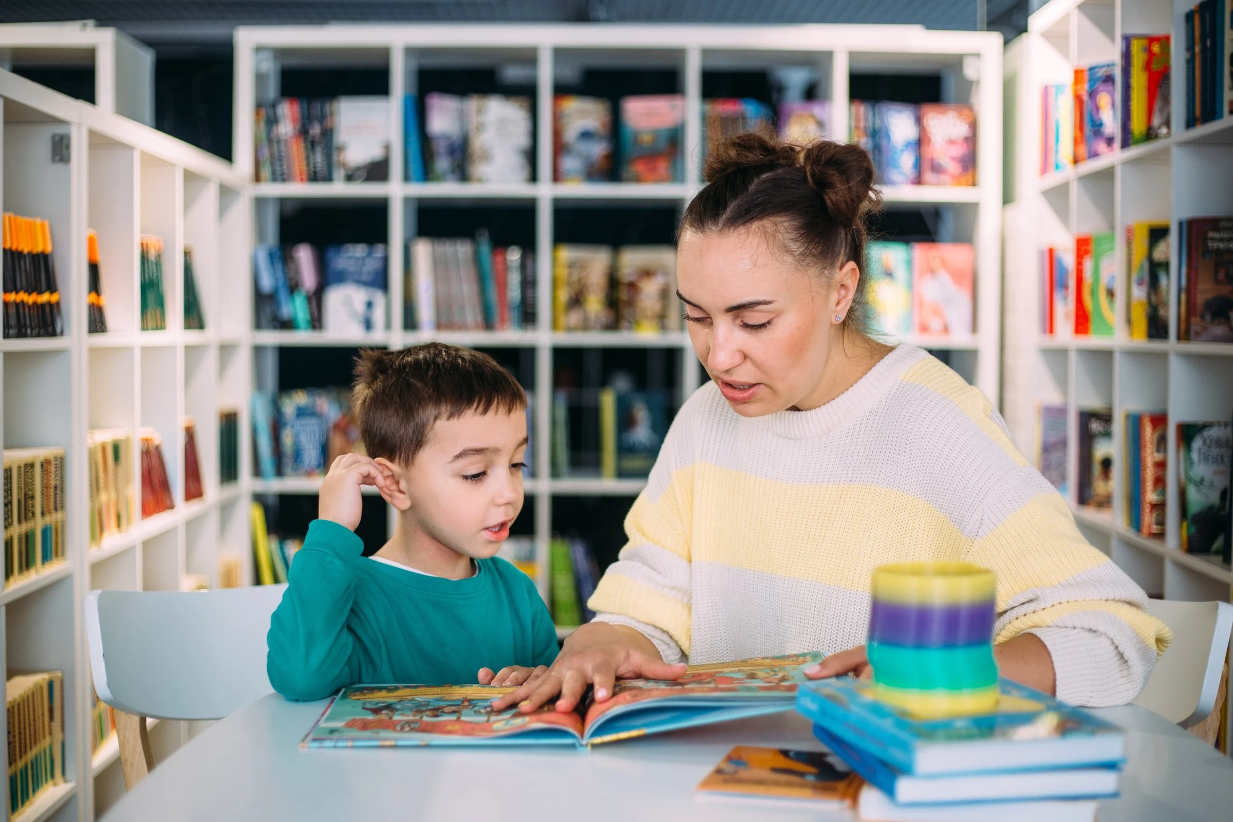 Nanny supporting early literacy development through reading activities