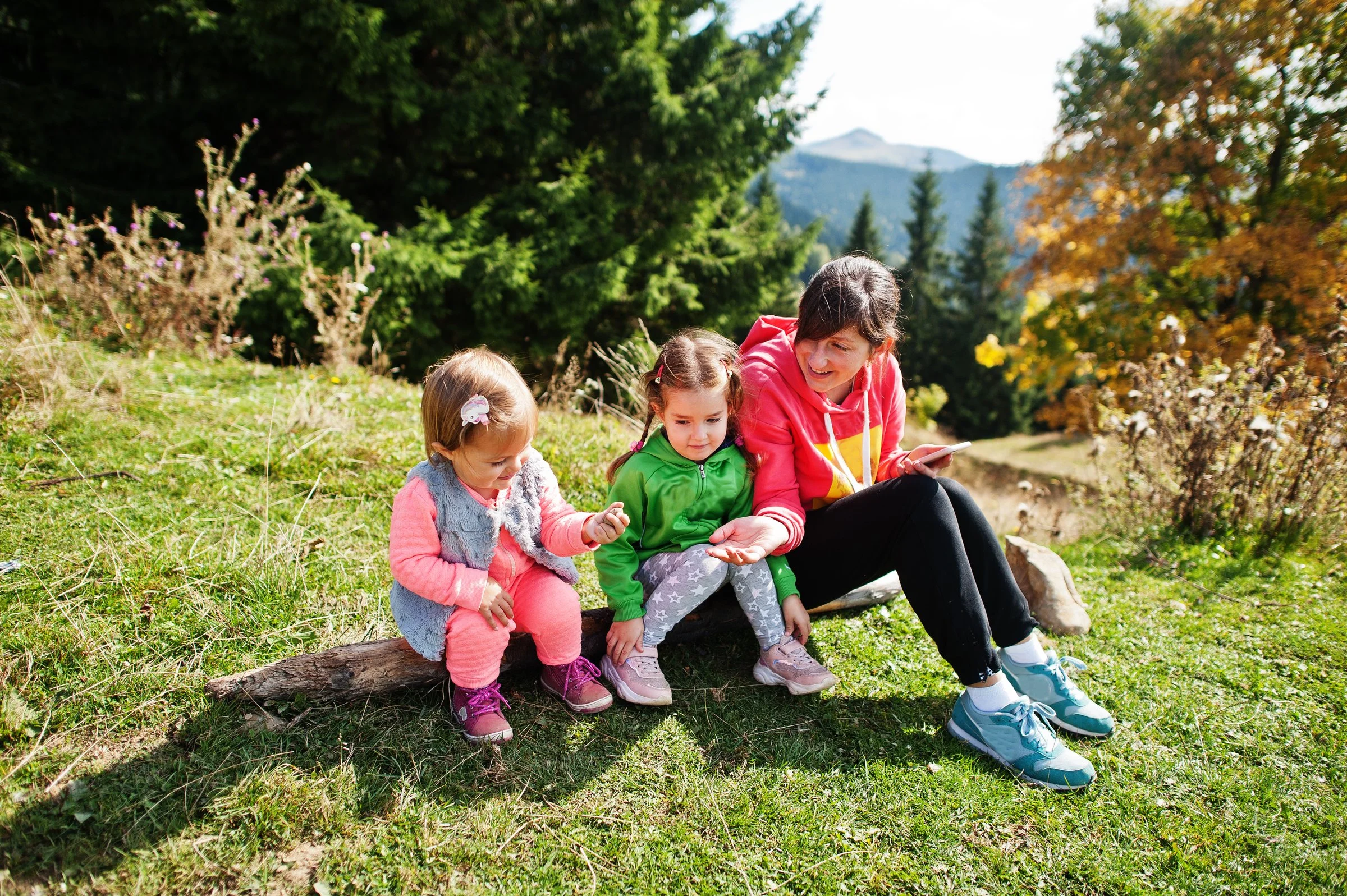 Nanny teaching children about nature during Cleveland outdoor activity