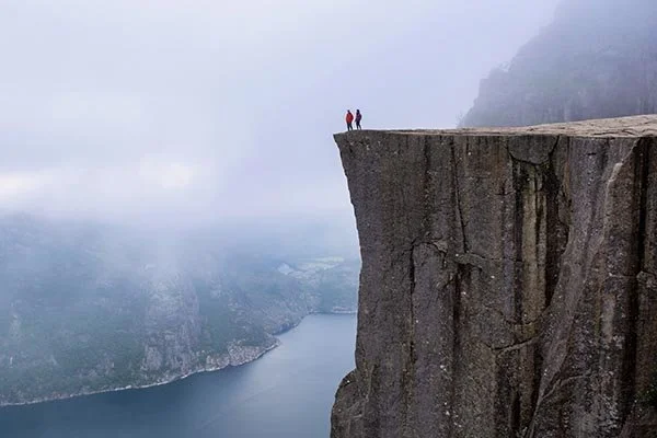 couple standing on the edge of a cliff