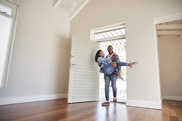 wife being carried into new home after wedding
