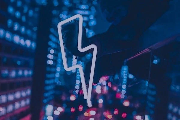 white lightning bolt in front of a blurred street backdrop