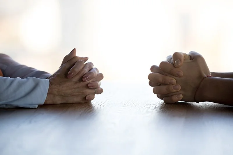 two hands crossed across from each other