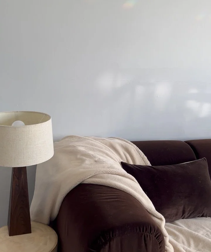 Tone, shape, texture and scale.

The dark chocolate tone and timber bring weight, while the lighter textile and lamp soften the room and keep it feeling balanced.

If you&rsquo;d like to book a consultation, you can submit an enquiry through my websi